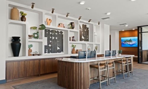 a leasing office with a desk, chairs and computers