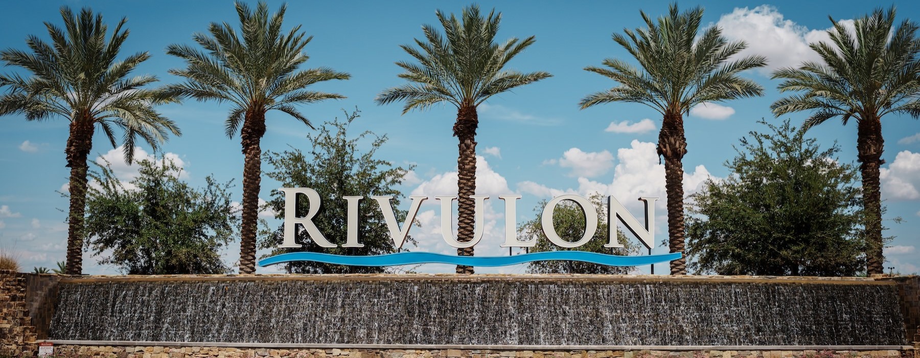 a large sign with palm trees